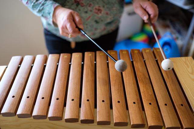 Person playing a wooden xylophone