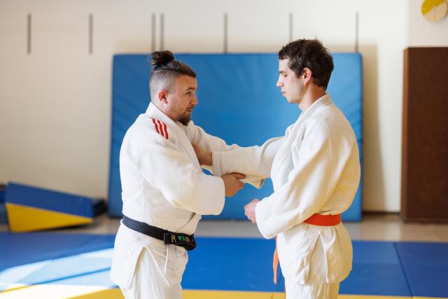 Two men practicing Para Judo in a dojo