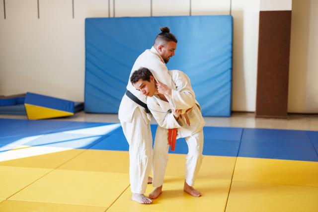 Two men practicing Para Judo in a dojo