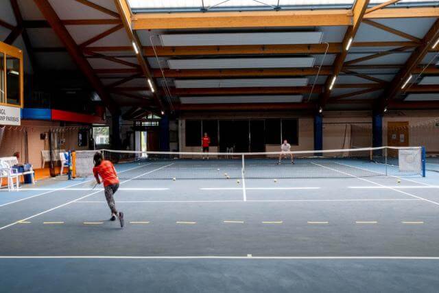 a man and a woman play tennis