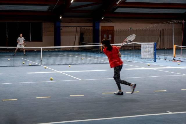 a man and a woman play tennis